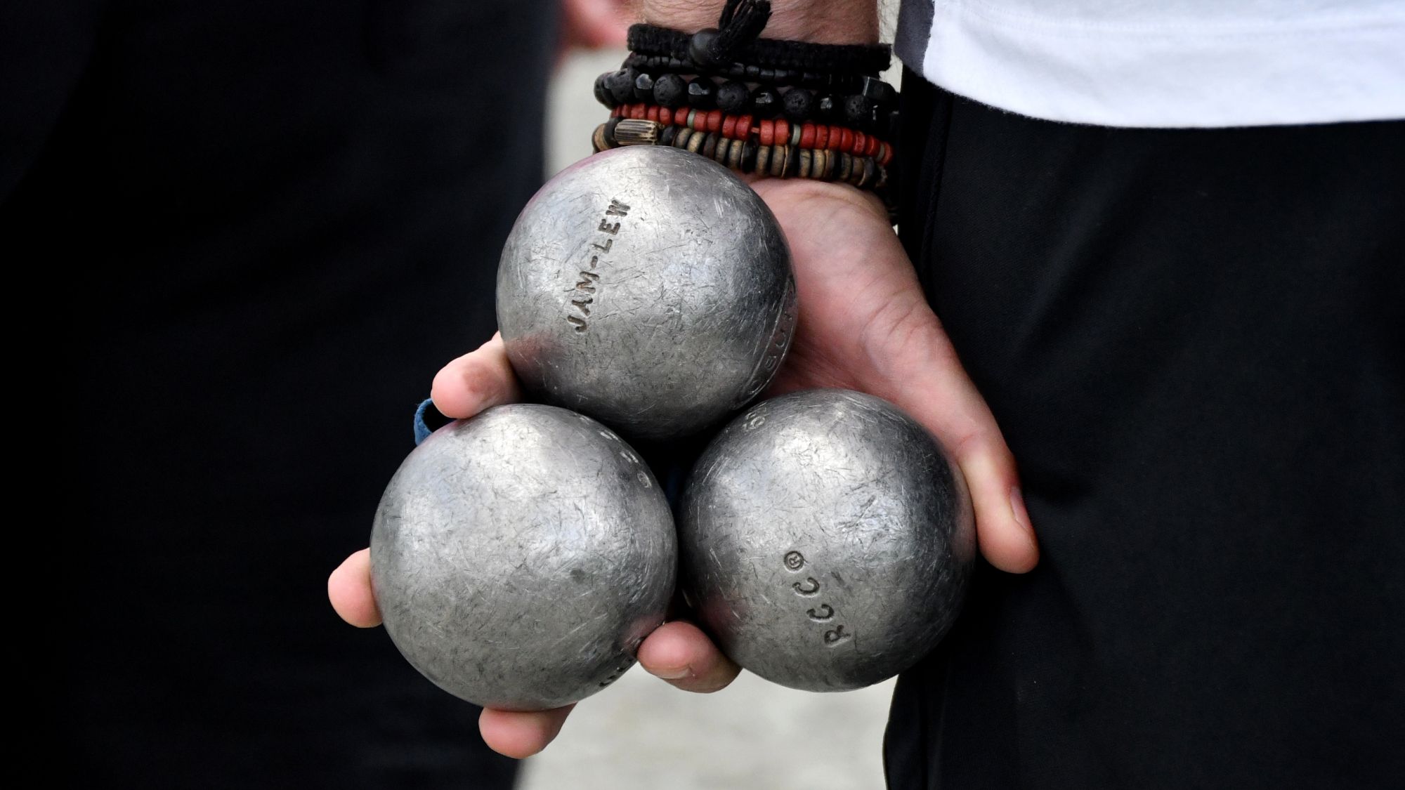 A set of pétanque boules with the players name engraved