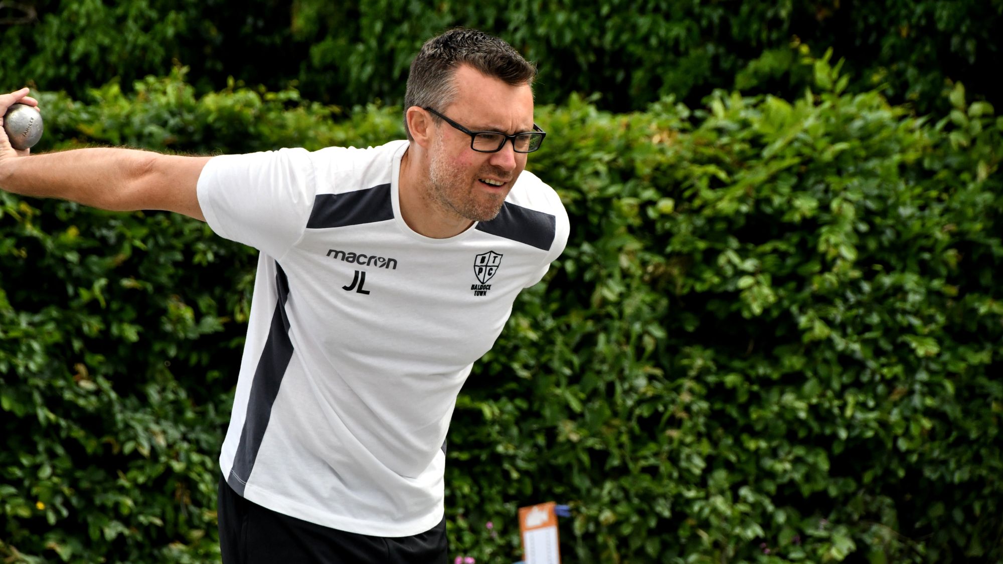Pétanque player Jamie Lewis taking a shot
